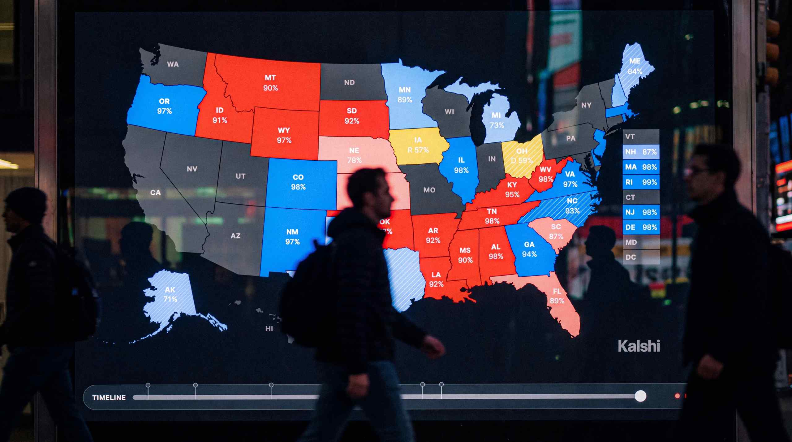 A man walking by a USA map that shows the country broken down by Democratic and Republican ridings.